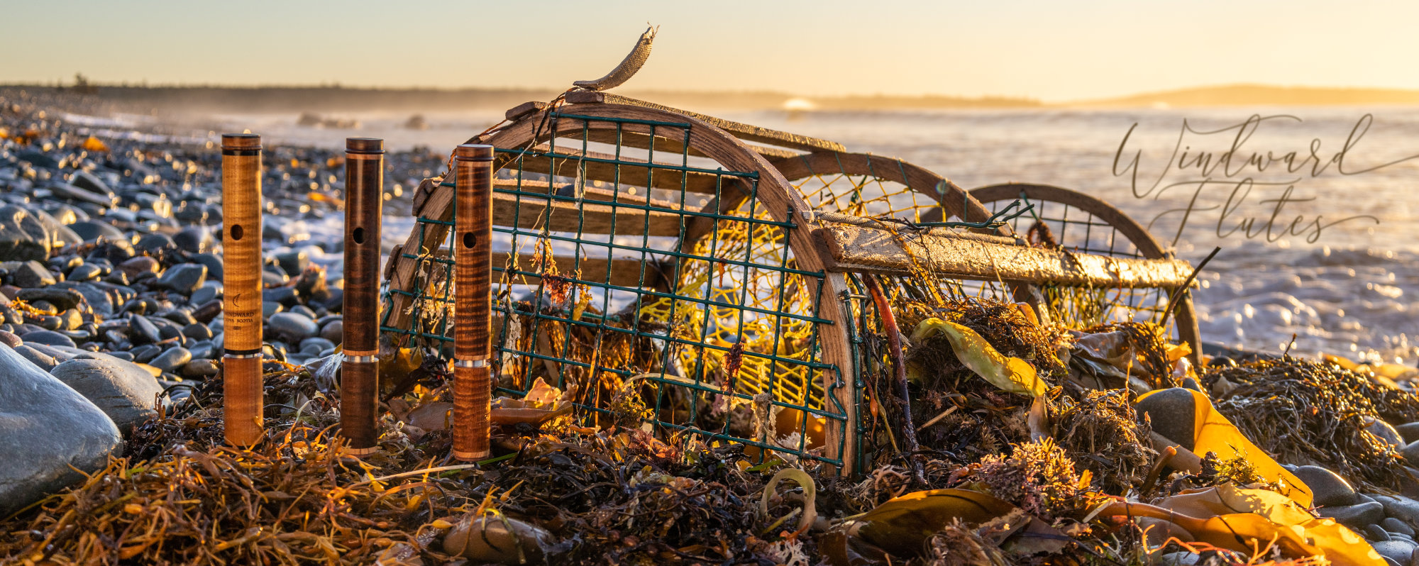 Three Canadian Thermally treated headjoints in front of a lobster trap at sunrise on stony beach